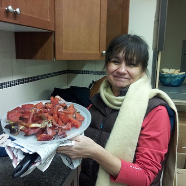 Sharing salmon Cheryl sharing smoked salmon with ANTH/PSYC 338 students, North Oyster Recreation Centre. Feb 2, 2014.