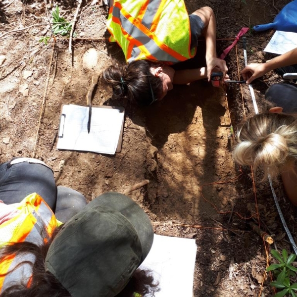 Archaeology methods field school with Dr. Marina LaSalle. Up-close with a tape measure. Field school