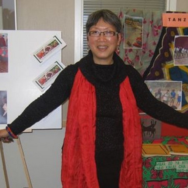 Friday International Development Week Event Dr Lim standing between two displays representing activities by members of the Anthropology Department. To her right is information on FOB and Fertile Ground, while to her left, the Tanzania Field School. Februa