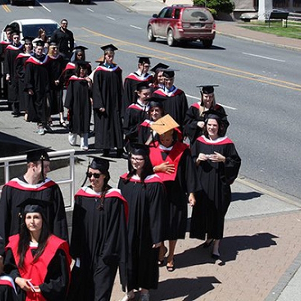 Procession Outside Port Theatre Desiree with cedar mortar board; Nicole immediately behind Desiree. Photo courtesy of VIU staff photographer.