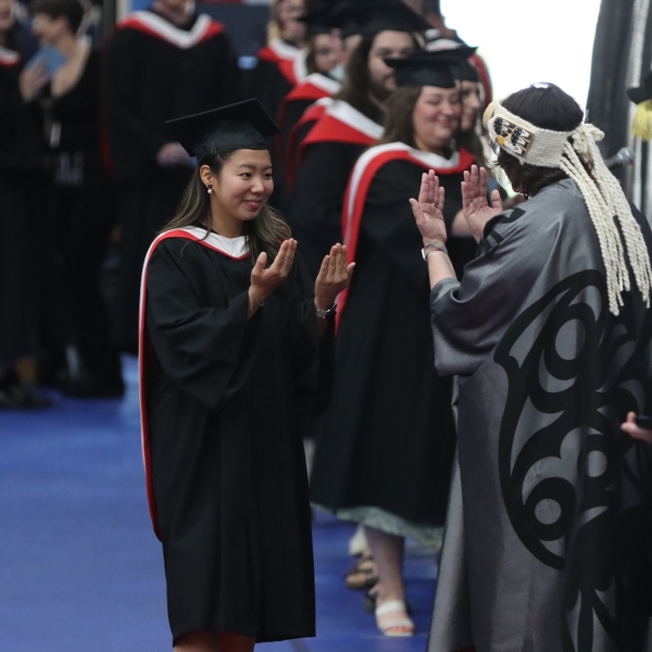 Jina You receiving her degree from President Saucier. June 22, 2023.