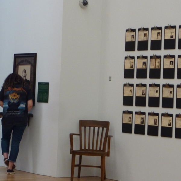 ANTH 390E field trip to the Chinese Canadian Museum. Two students looking at documentation of individuals.
