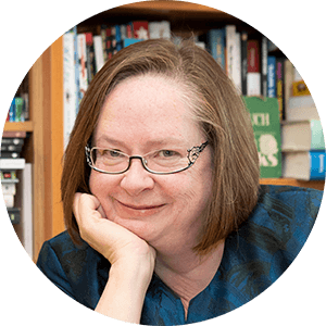 A smiling woman wearing glasses.