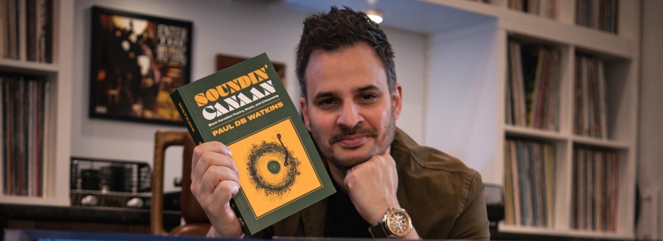 Dr. Paul Watkin holding his new book Soundin' Canaan.