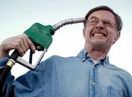 man holding gas nozzle to head as if a gun