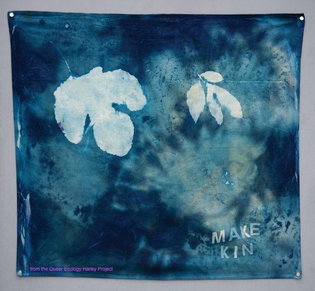 A handkerchief painted in various shades of blue, featuring a pale blue leaf pattern.