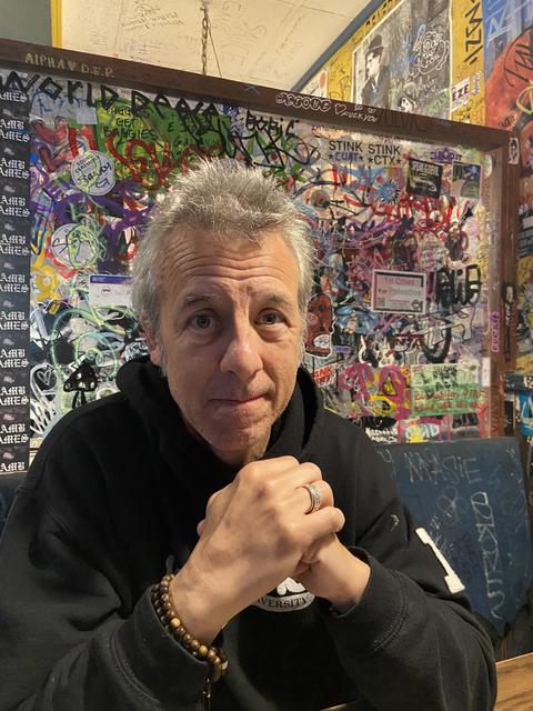 Man in front of abstract painting