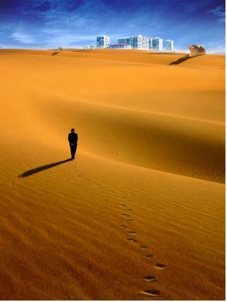man in desert city on horizon