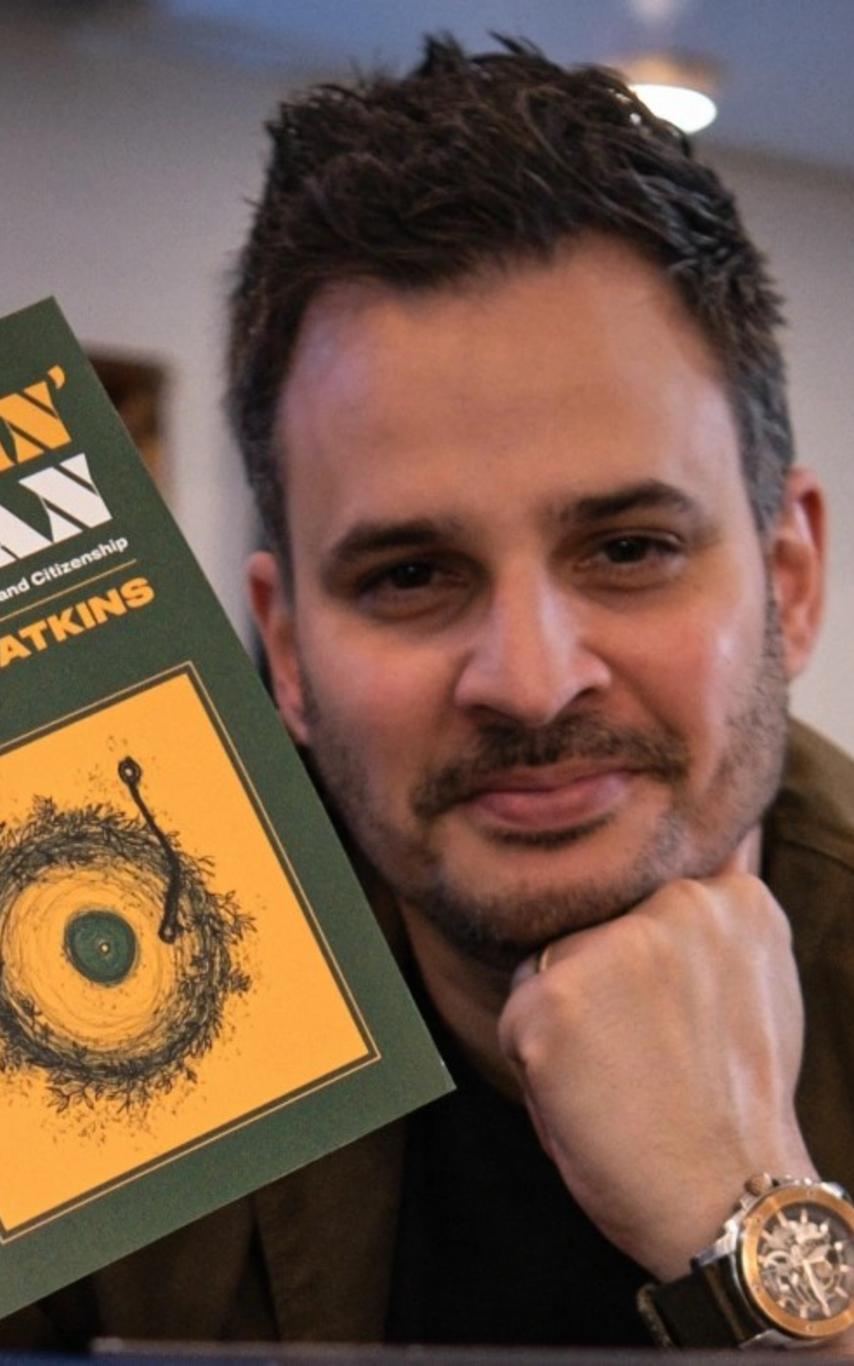 Dr. Paul Watkin holding his new book Soundin' Canaan.